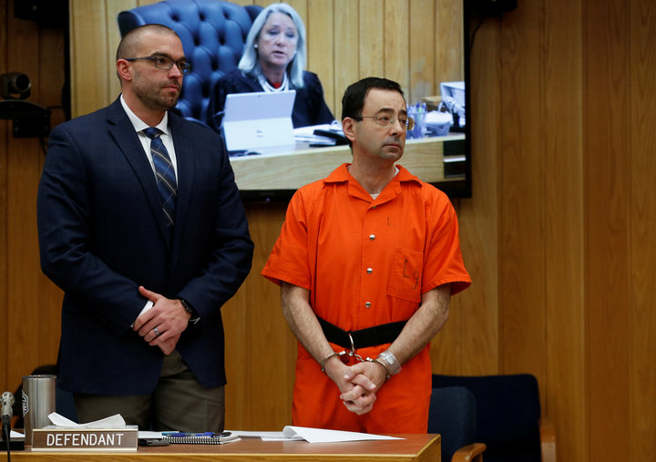 Larry Nassar, a former team USA Gymnastics doctor who pleaded guilty to sexual assault charges, stands with his attorney Matt Newburg as Judge Janice Cunningham gives instructions during Nassar's second sentencing in Charlotte
